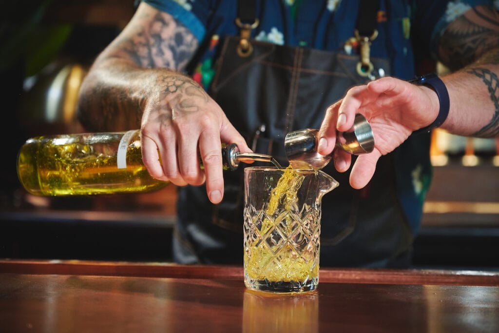 bartender making a cocktail as an example of one of the types of food photography clients