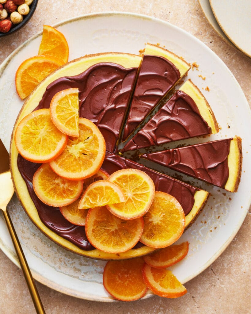 https://thebiteshot.com/wp-content/uploads/2022/06/orange-chocolate-cheesecake-1-after-1-819x1024.jpg