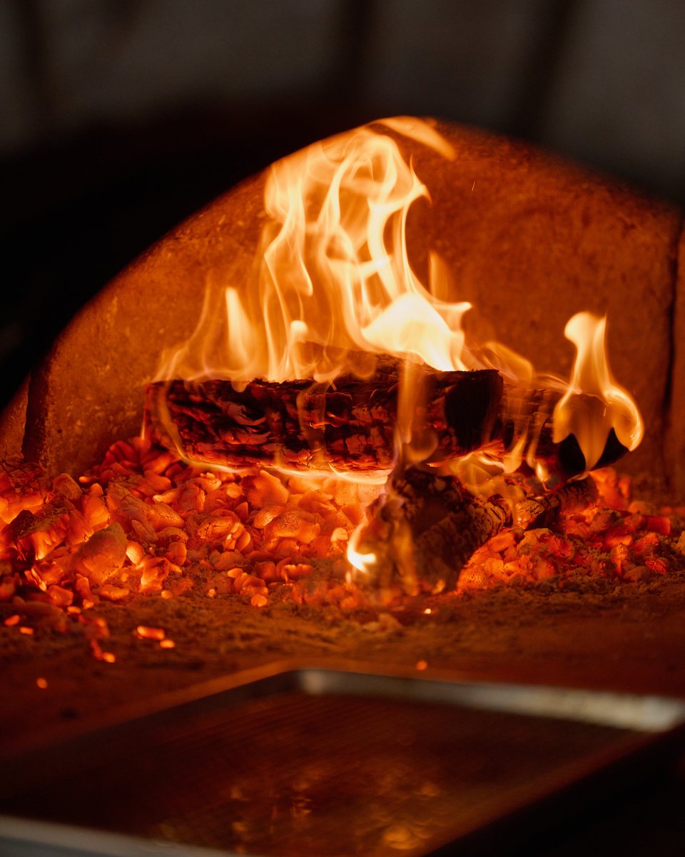Wood-fired oven with flames and embers
